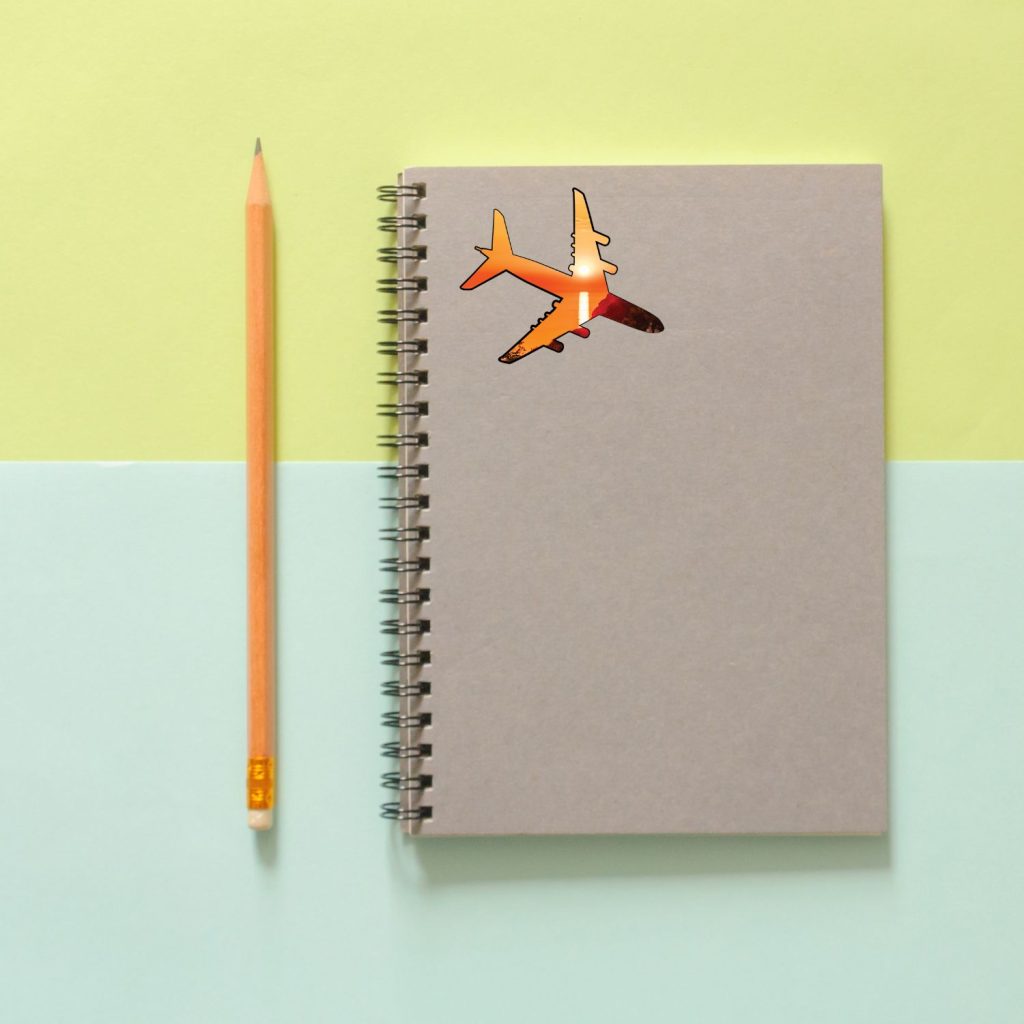 airplane travel sticker on journal